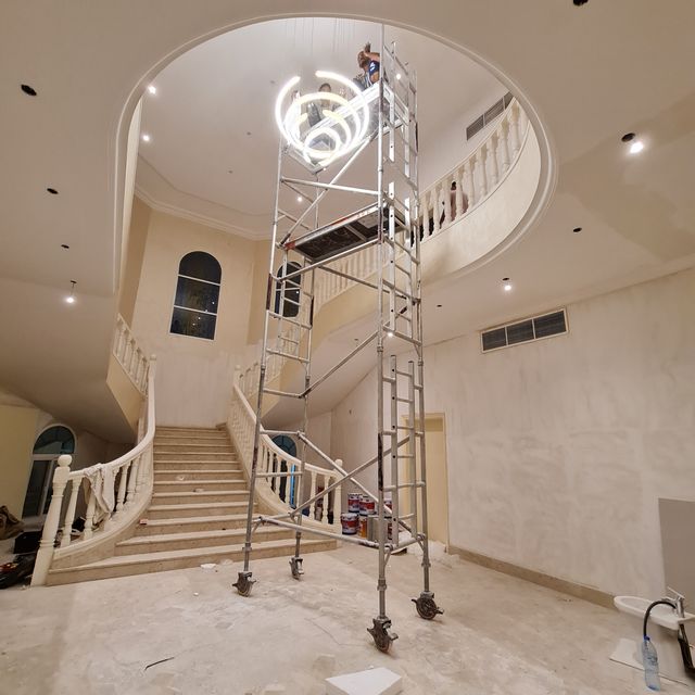 Chandelier in a double-height stair hall: finished