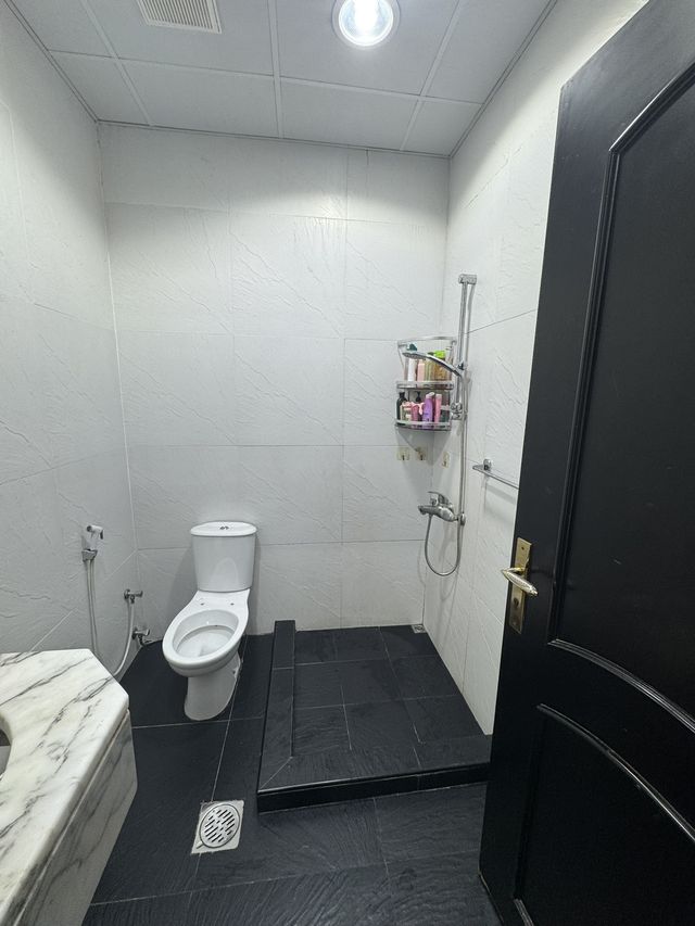 Bathroom with a dark floor and marble vanity