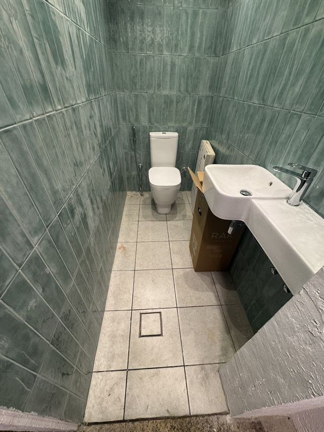 Green tiled shower room
