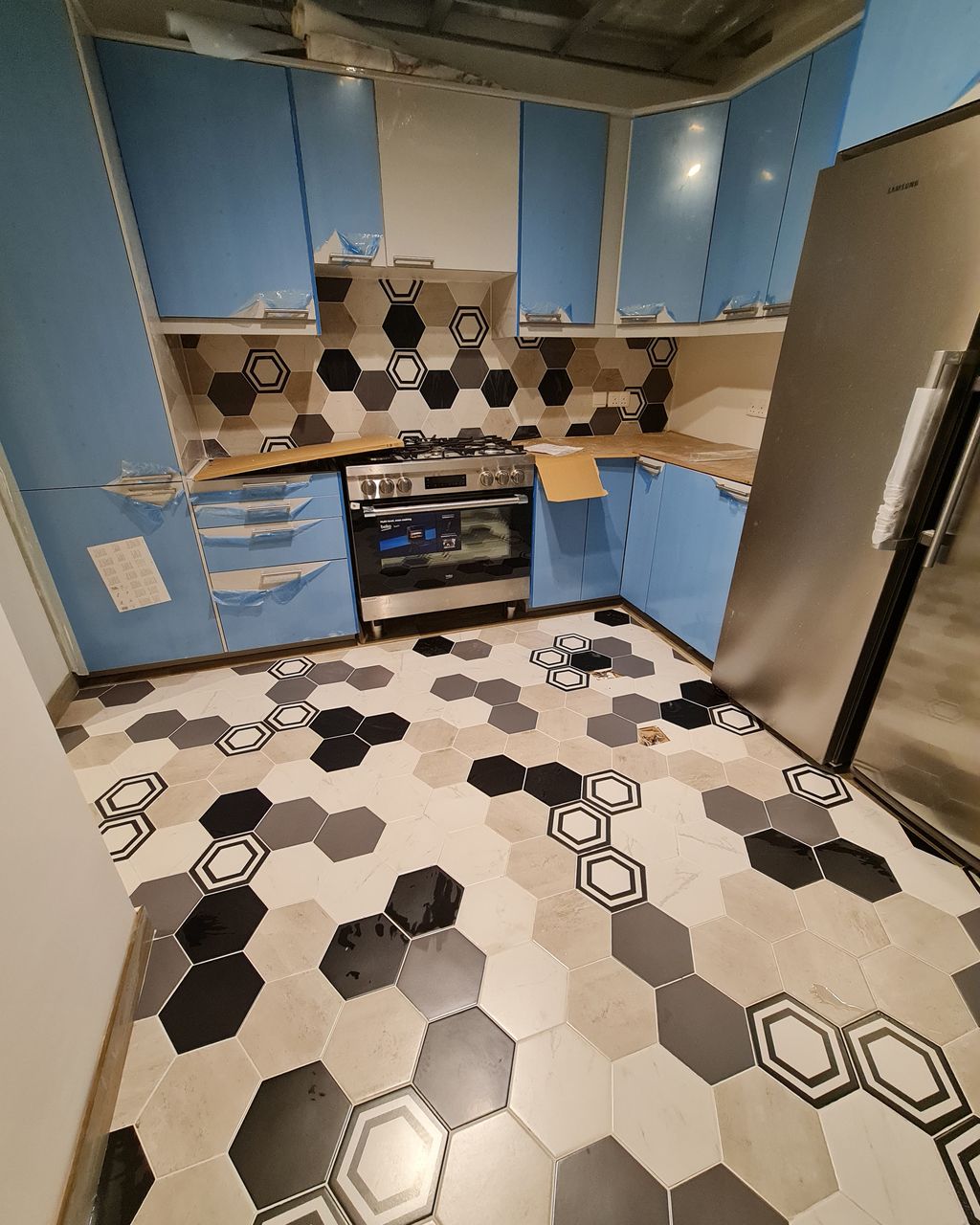 After: Kitchen fit-out with a hexagon tile floor