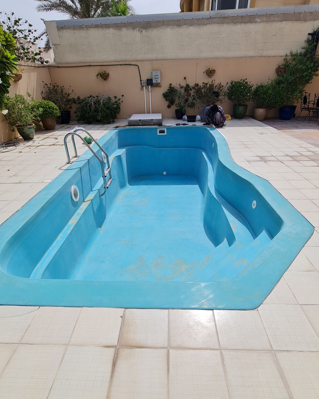 Before: Faded pool repainted