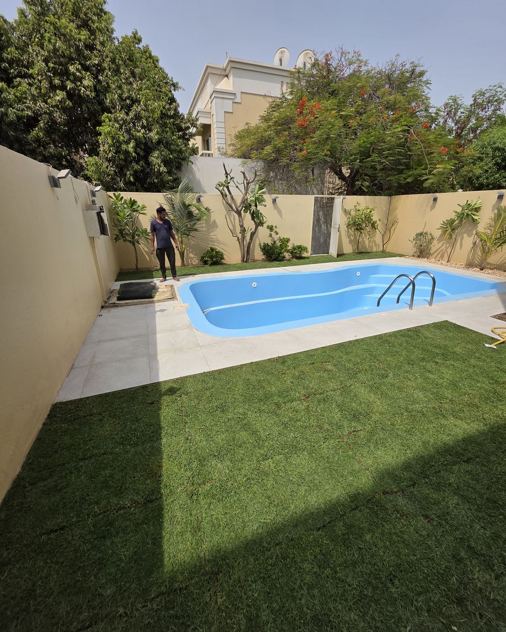 After: Pool surround paved and new lawn laid