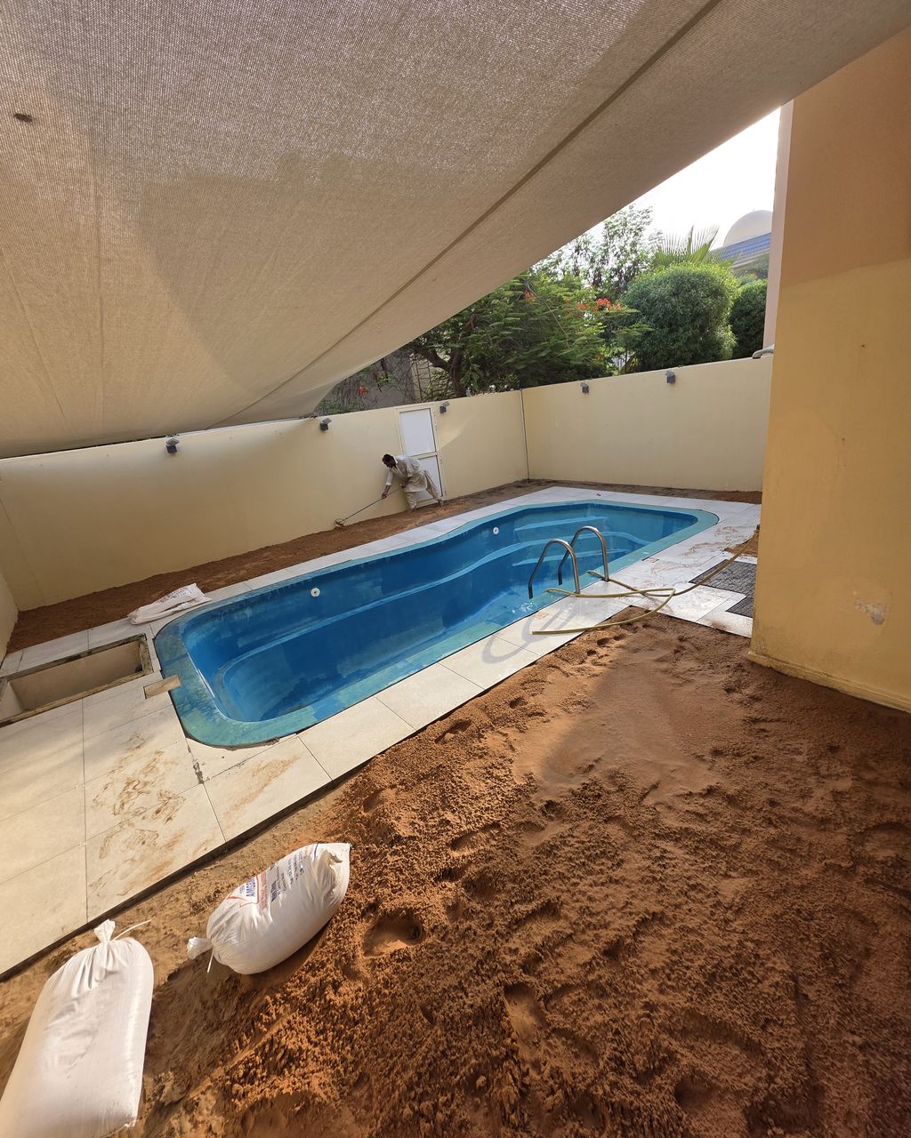 Before: Pool surround paved and new lawn laid
